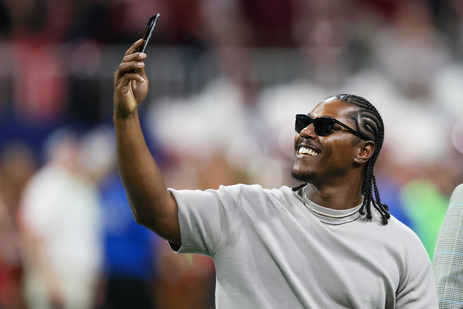 Georgia Bulldogs standout Knowshon Moreno documents the SEC Championship football game against the Alabama Crimson Tide at the Mercedes-Benz Stadium in Atlanta, on Saturday, December 2, 2023. (Jason Getz / Jason.Getz@ajc.com)