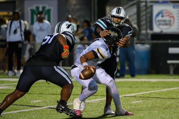 Jaden Duckett, quarterback for Sprayberry High School, escapes a sack during an Aug. 30 game against Kennesaw Mountain.