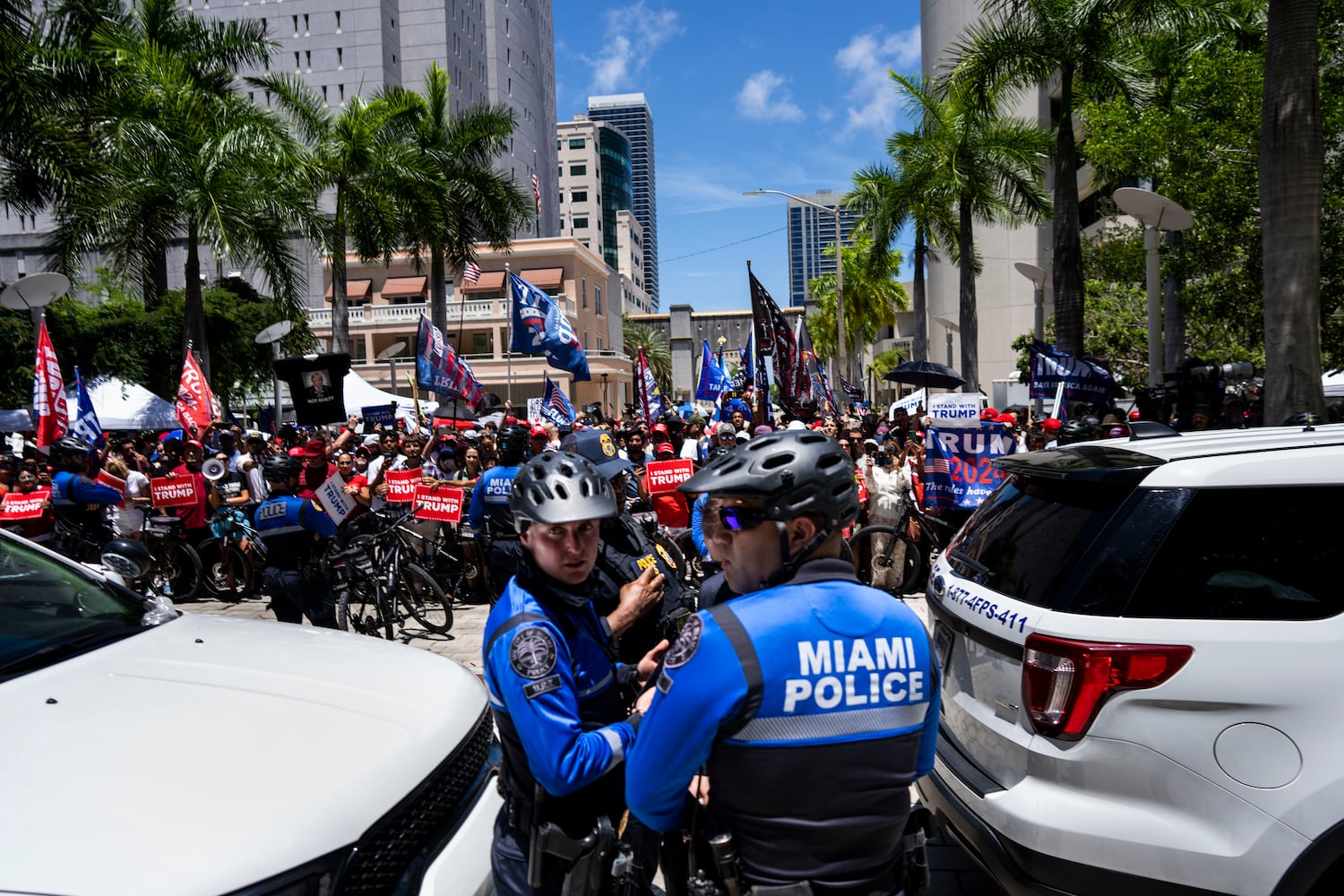 Miami Police watch over supporters of former President Donald Trump outside the Wilkie D. Ferguson Jr. U.S. Courthouse while Trump was making his first court appearance inside in Miami, June 13, 2023. (Doug Mills/The New York Times)