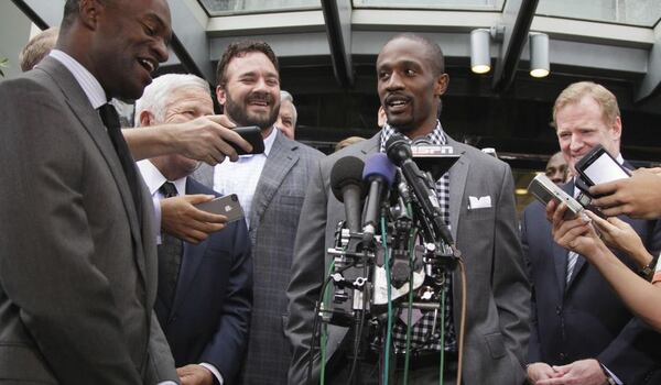  In this July 25, 2011 photo, Domonique Foxworth of the Baltimore Ravens, center, speaks during a news conference at the NFL Players Association in Washington after the NFL Players Association executive board and 32 team reps voted unanimously to end a lockout. Today, Foxworth is a former NFL cornerback and a Harvard Business School graduate. (AP Photo/Carolyn Kaster, File)