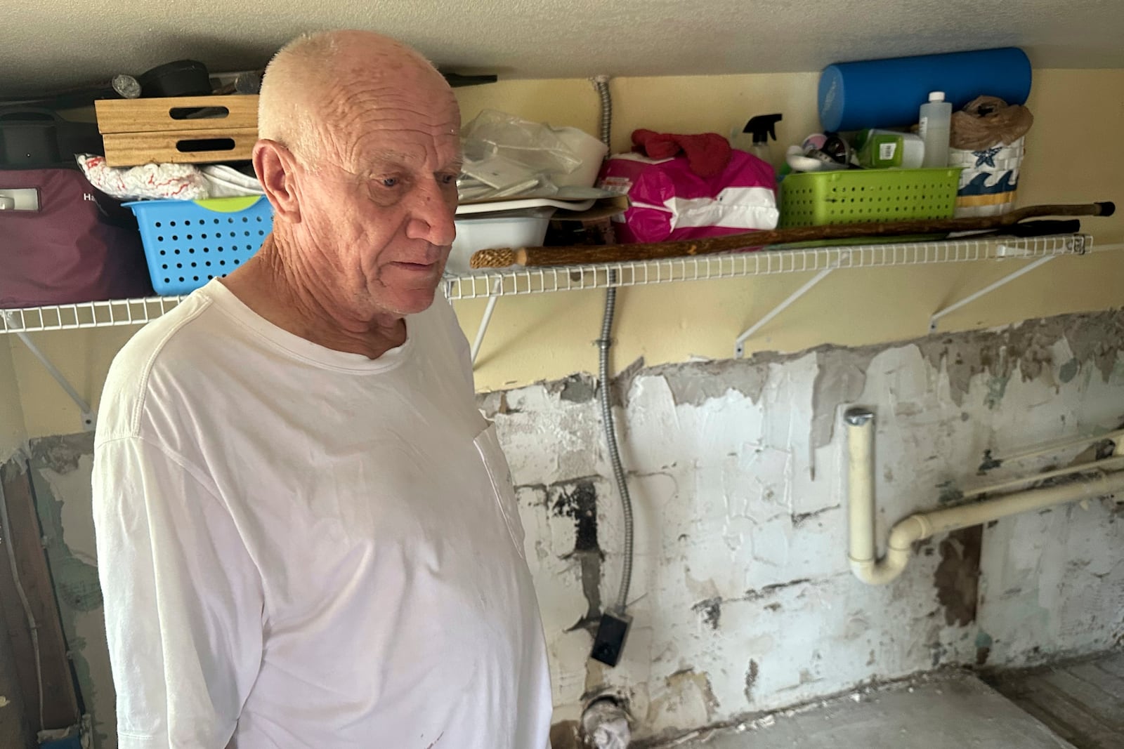 Mark Praught stands inside his storm-damaged home from Hurricane Milton in Cortez, Fla., on Saturday, Oct. 12, 2024. (AP Photo/Russ Bynum)