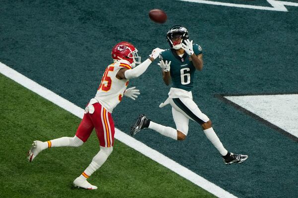 Philadelphia Eagles wide receiver DeVonta Smith (6) catches a touchdown pass ahead of Kansas City Chiefs cornerback Jaylen Watson (35) during the second half of the NFL Super Bowl 59 football game, Sunday, Feb. 9, 2025, in New Orleans. (AP Photo/Charlie Riedel)