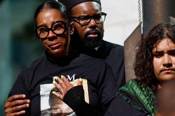 A woman with a Cornelius Taylor t-shirt reacts as they pray outside Atlanta City Hall on Monday, Feb. 3, 2025.
(Miguel Martinez/ AJC)