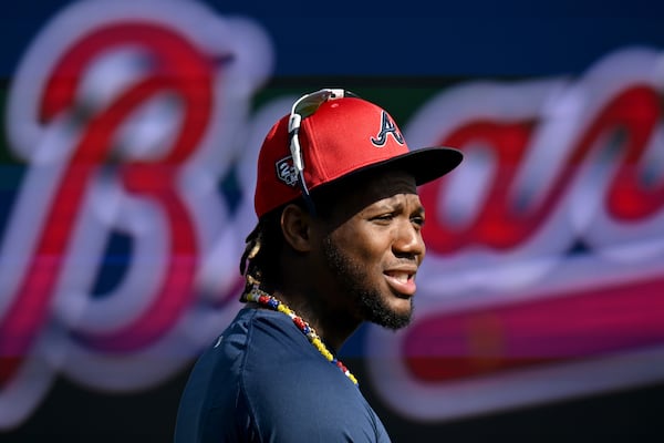 Atlanta Braves right fielder Ronald Acuna Jr. talks with teammates and coaching staff before taking batting practice during spring training workouts at CoolToday Park, Friday, February, 16, 2024, in North Port, Florida. (Hyosub Shin / Hyosub.Shin@ajc.com)