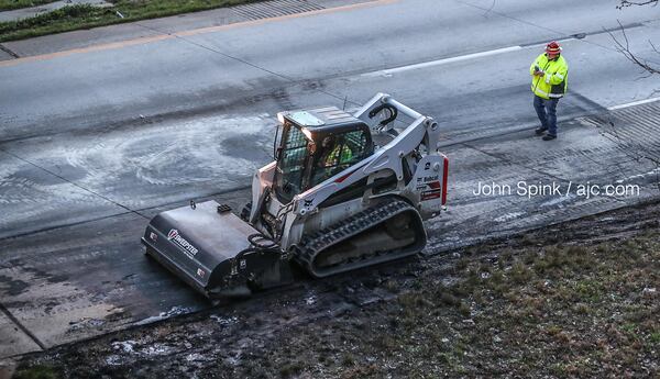 Crews worked to clean up the charred vehicle and investigate the fire on the side of I-675 in Clayton County.