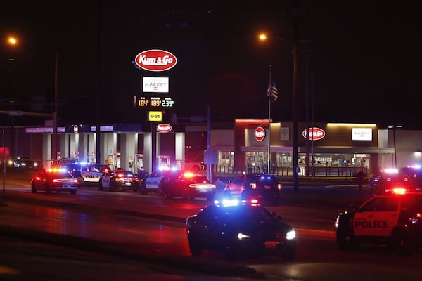 Police respond to the scene of a shooting at a gas station in Springfield, Mo, on Sunday, March 15, 2020. Police Chief Paul Williams said Monday morning, a Springfield police officer, three citizens and the gunman were killed. (Nathan Papes/The Springfield News-Leader via AP)