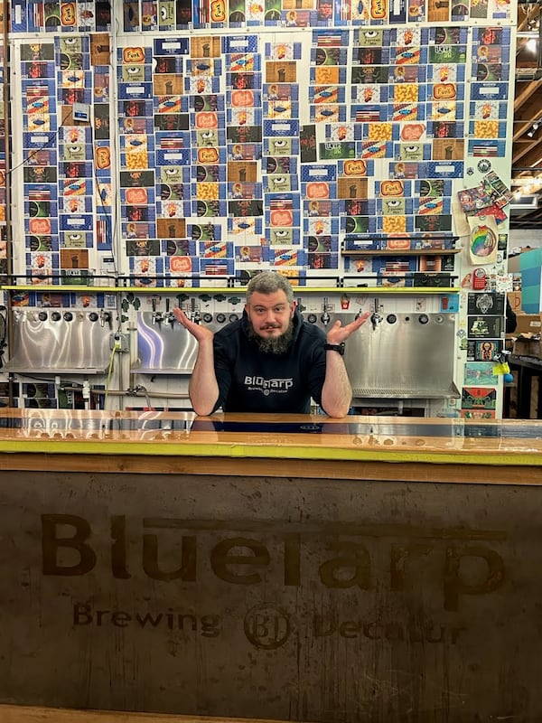 Owner of BlueTarp Brewing Tom Stahl poses behind the bar at the downtown Tucker taproom. (Courtesy of BlueTarp Brewing)