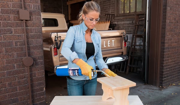 Nicole Curtis, host of HGTV’s “Rehab Addict,” demonstrates how to use a blowtorch during a recent trade show. She’ll be in Atlanta Friday as part of a similar event. Contributed by Zeno Group