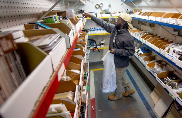 Moma Sayplay picks up the supplies he will need for the day while working around the Gables Mills Apartments Monday, February 10, 2020. STEVE SCHAEFER / SPECIAL TO THE AJC