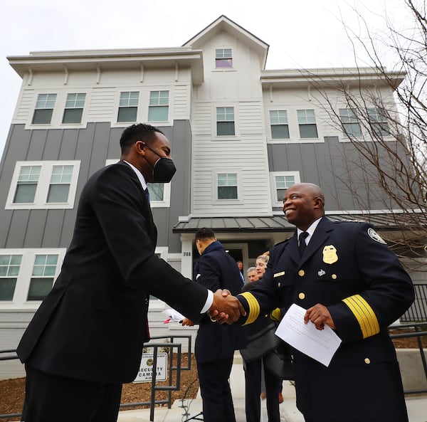 Atlanta Mayor Andre Dickens and Police Chief Rodney Bryant greet each other as they arrive at the ribbon cutting for Unity Place, an apartment complex for Atlanta Police recruits, on Wednesday, Feb. 2, 2022, in Atlanta. (Curtis Compton / Curtis.Compton@ajc.com)