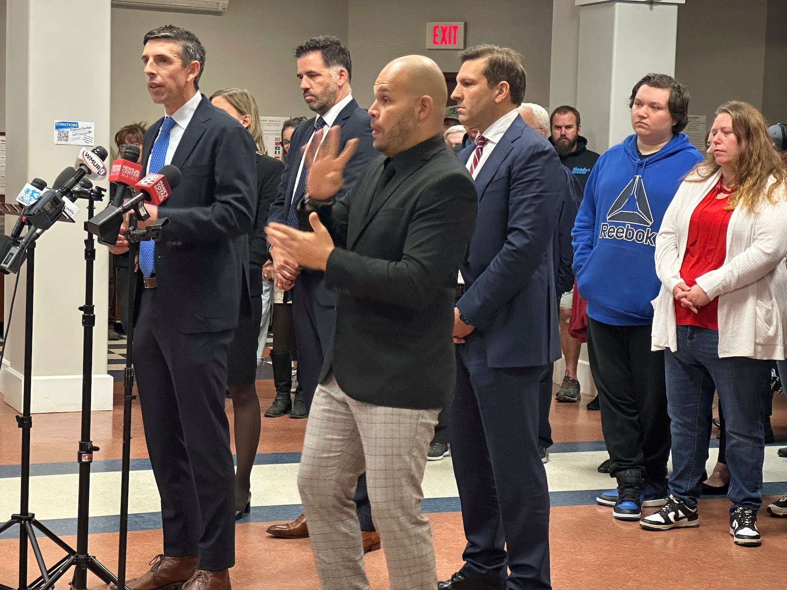 Attorney Travis Brennan speaks at a news conference in Lewiston, Maine, on Tuesday, Oct. 15, 2024, along with victims of the 2023 Lewiston mass shooting. (AP Photo/Patrick Whittle)