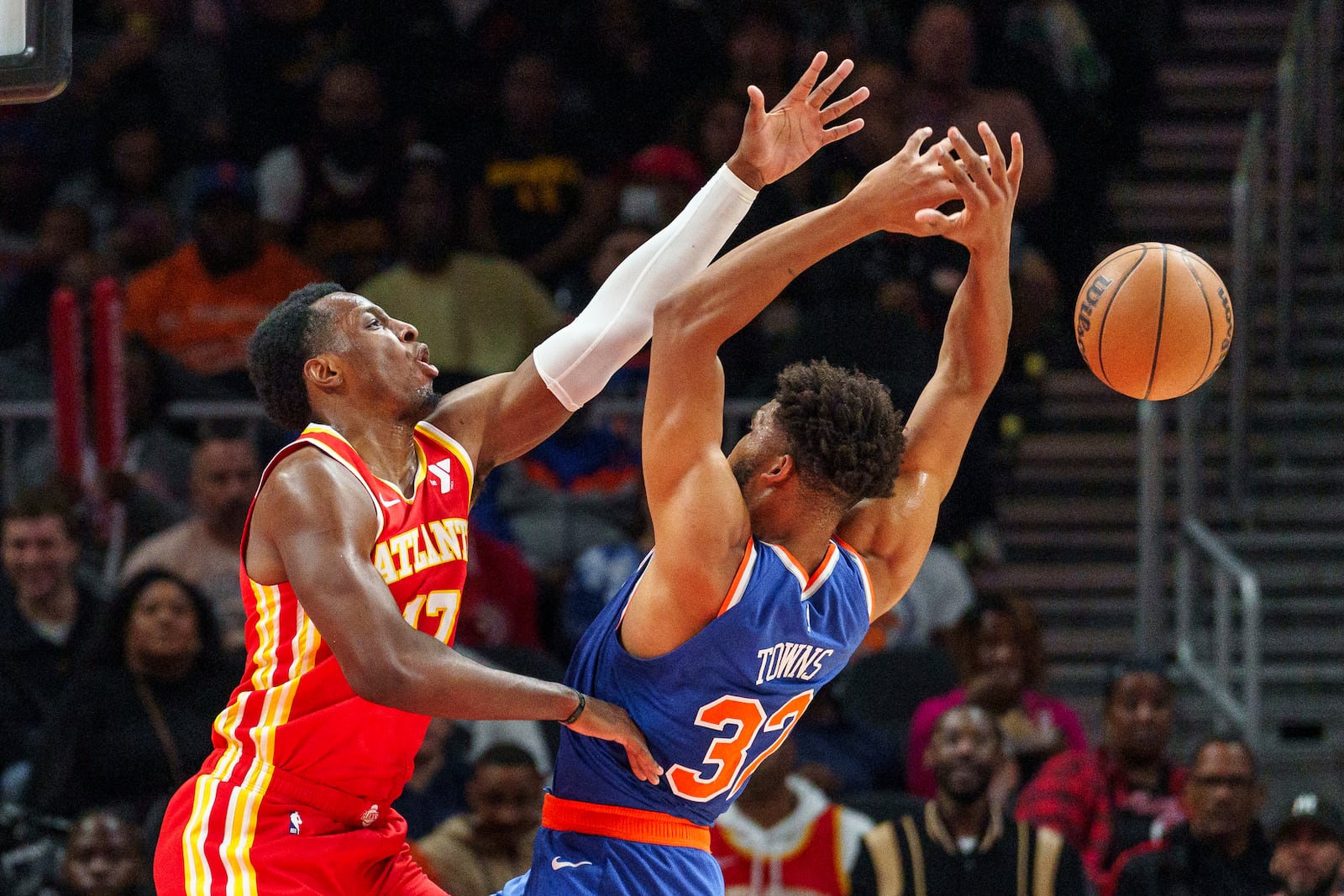 Atlanta Hawks forward Onyeka Okongwu, left, blocks a shot attempt by New York Knicks center Karl-Anthony Towns, right, during the first half of an NBA basketball game, Wednesday, Nov. 6, 2024, in Atlanta. (AP Photo/Jason Allen)