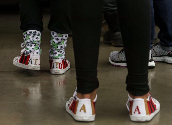 Atlanta United fans display their creative side by wearing decorative shoes to the victory rally.