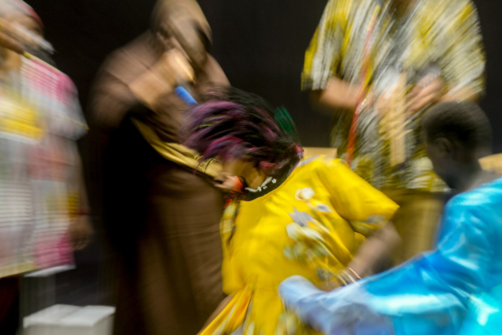 In this image taken with a slow shutter speed, Sudanese Camirata troupe dancers perform a "Al Hamal Rakd" dance from West Sudan, during a show at the Russian culture center in Cairo, Egypt, Sunday, Sept. 15, 2024. (AP Photo/Amr Nabil)