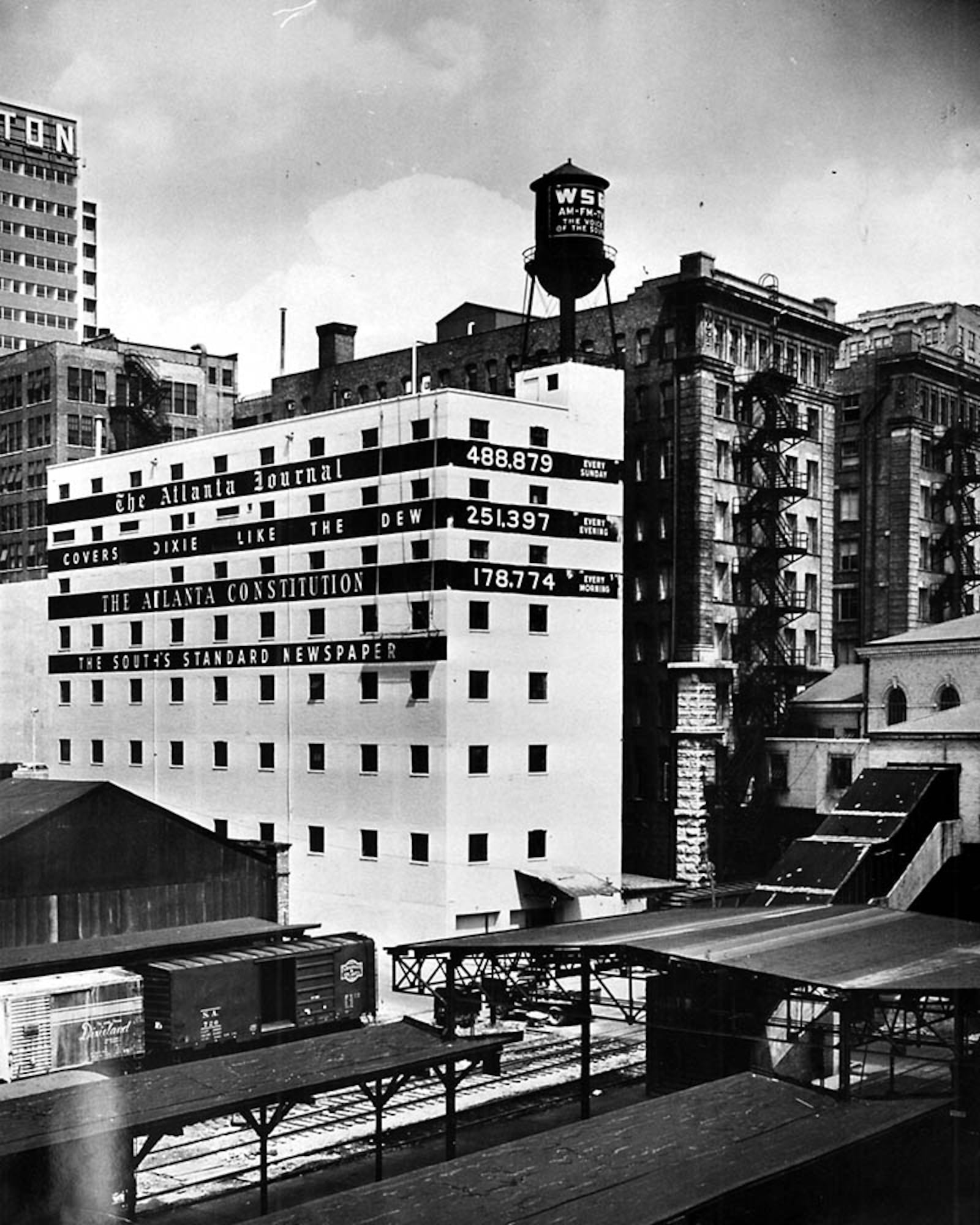 In this photo from 1959, the back of the 10 Forsyth building advertises the papers’ circulation figures, as well as WSB on the water tower. (AJC file)