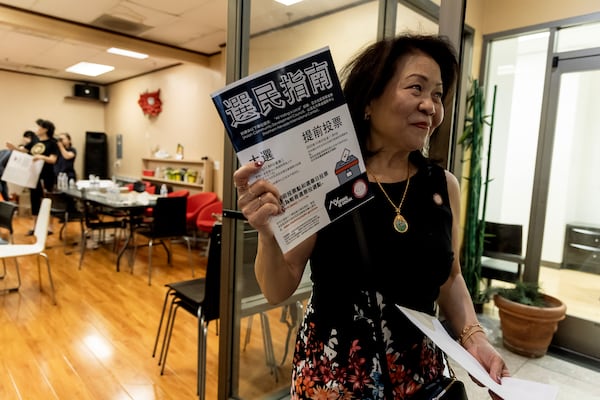 Vida Lin, president and founder of the Asian Community Development Council, holds a voter information booklet her group translated into Chinese at the annual Dragon Boat Festival in Las Vegas on Wednesday, June 5, 2024. (Photo by Christopher Lomahquahu/News21)