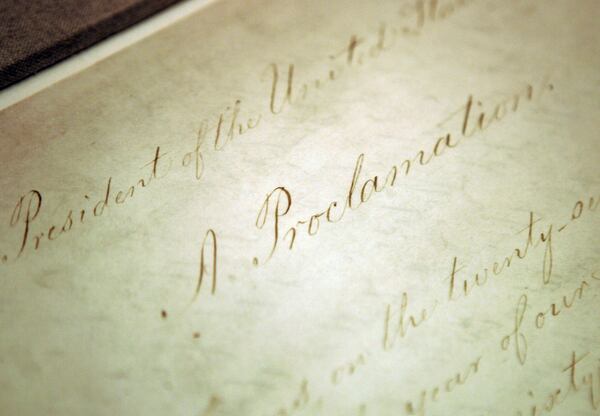 This Feb. 18, 2005, file photo shows the original Emancipation Proclamation on display in the Rotunda of the National Archives in Washington. President Abraham Lincoln first issued the Emancipation Proclamation declaring all slaves free in Confederate territory on Sept. 22, 1862. New York Gov. Andrew Cuomo signed an executive order in June 2020 recognizing Juneteenth as a paid holiday for state employees to commemorate the emancipation of slaves in the U.S. (AP Photo/Evan Vucci, File)