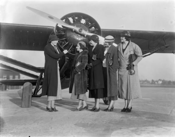 Amelia Earhart talks with women aviators from the international women's pilot organization the Ninety-Nines, during an event at Candler Field in 1934. From left to right: Earhart, Erin Darden, Ruth Mohr, Madeline Johnson, and Charlotte Frye. (George Cornett / AJC Archive at GSU Library AJCN030-070c)