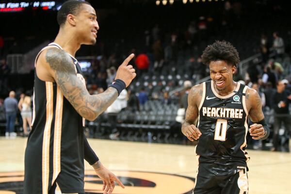 Hawks forward John Collins (20) and guard Brandon Goodwin (0) celebrate after a 102-95 victory. (AP Photo/Brett Davis)