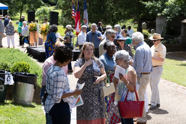 People gather together and talk after the Historic Oakland Foundation ceremony for the newly restored African American Burial Grounds at Oakland Cemetery on Friday, June 10, 2022. (Steve Schaefer / steve.schaefer@ajc.com)