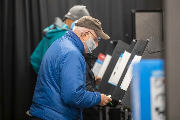 12/14/2020 —  Marietta, Georgia —  Cobb County resident Stephen Imler, 69, uses an electronic voting machine to cast his ballot during early voting at the Cobb County Elections and Voter Registration Office in Marietta, Monday, December 14, 2020.  (Alyssa Pointer / Alyssa.Pointer@ajc.com)