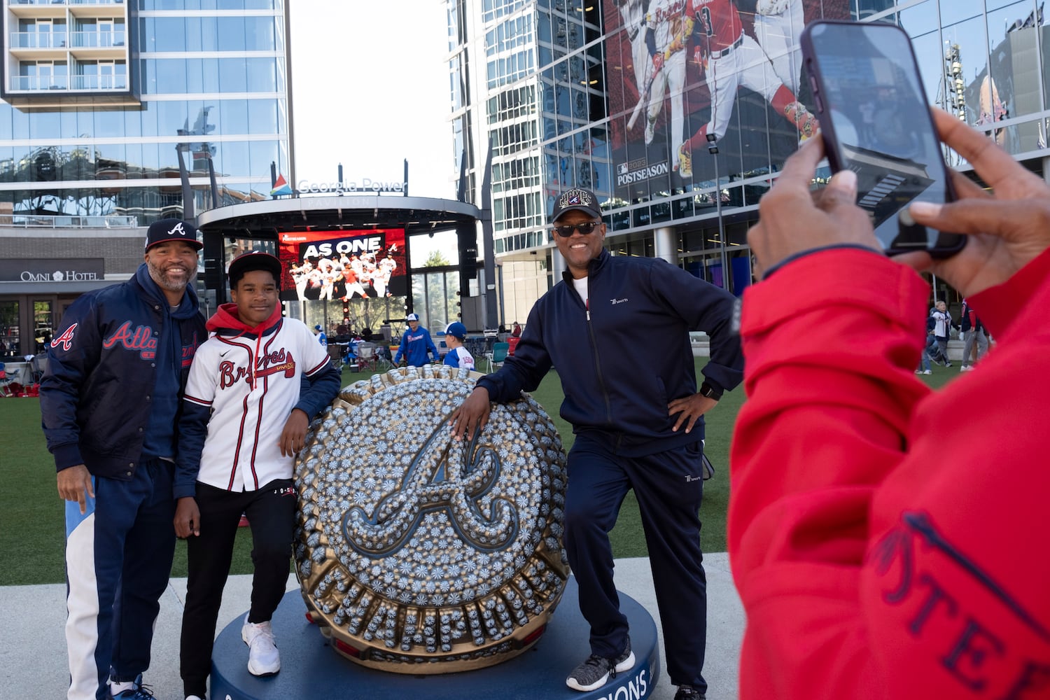 Braves fans Chris Compton, from left, his son Caleb Compton and uncle Hayes Fountain pose for a photo at the Battery before game one of the National League Division Series in Atlanta on Saturday, Oct. 7, 2023.ÊThe Comptons came from Houston for the game. (Ben Gray / Ben@BenGray.com)