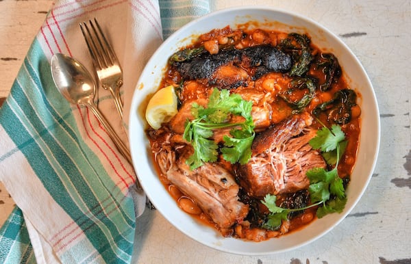 Harissa-rubbed Pork Shoulder with White Beans and Chard is based on a recipe from Alison Roman’s “Nothing Fancy” (Potter, $32.50). STYLING BY SUSAN PUCKETT / CONTRIBUTED BY CHRIS HUNT PHOTOGRAPHY