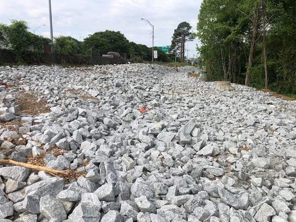 After the city cleared an encampment near Cheshire Bridge, The Atlanta Journal-Constitution observed rocks on a verge where people had pitched tents. (Matt Reynolds with The Atlanta Journal-Constitution)