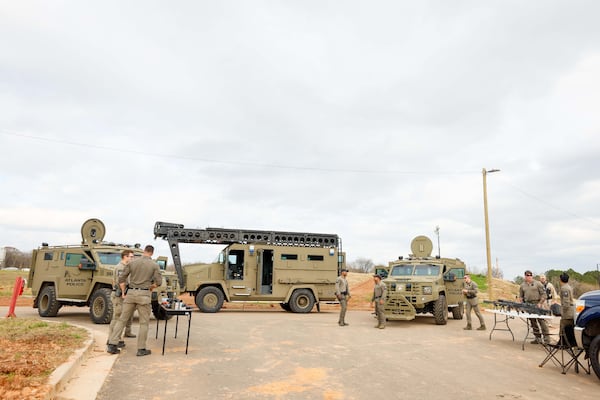 SWAT team members stand in front of armored vehicles and weapons during a media tour at the Atlanta Police Safety Training Center on Tuesday, Dec. 17, 2024. (Miguel Martinez/AJC)