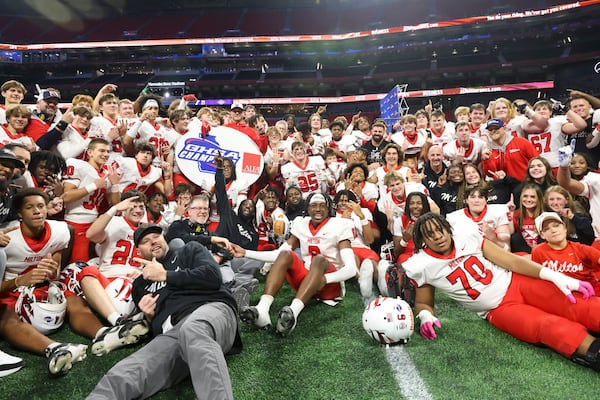 The Milton football team pose for a photograph after their win against Walton in the Class 7A GHSA State Championship game at Mercedes-Benz Stadium, Wednesday, December. 13, 2023, in Atlanta. Milton won 31-21. (Jason Getz / Jason.Getz@ajc.com)