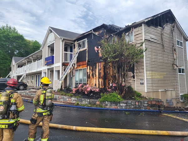 The 911 caller reported flames extending from the ground floor to the roofline and the nearby woods. 