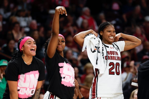 South Carolina guards Te-Hina Paopao, left, Raven Johnson and forward Sania Feagin (20) react to a South Carolina basket during the second half of an NCAA college basketball game against Florida in Columbia, S.C., Thursday, Feb. 13, 2025. (AP Photo/Nell Redmond)