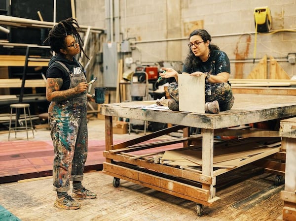 Muralist Charity Hamidullah talks with scenic artist Angela Bartone in Atlanta Ballet's scene shop.
(Courtesy of Andrew Thomas Clifton)