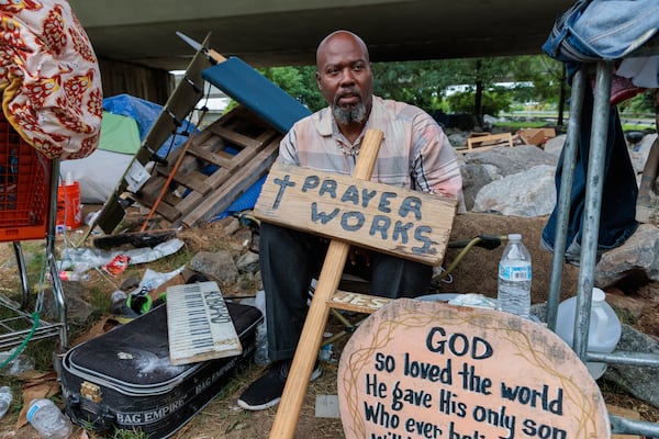 Thomas Lecky, 41, displays with his artwork at a homeless encampment in downtown Atlanta on Thursday, August 25, 2022. The city and the nonprofit Partners for HOME plan to shut down the encampment before Labor Day and find housing for the residents. Making art “centers me and reminds me of my purpose,” says Lecky. “If I didn’t have occupations and things that I do out here, I wouldn’t be able to survive.” (Arvin Temkar / arvin.temkar@ajc.com)