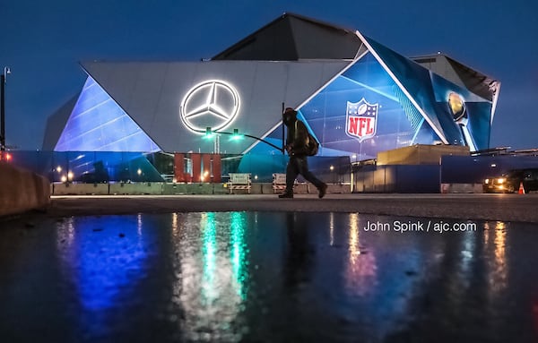 A thin layer of ice coats the ground outside Mercedes-Benz Stadium on Wednesday morning, where Super Bowl preparations are underway. JOHN SPINK / JSPINK@AJC.COM.