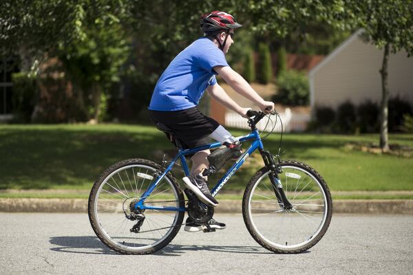 One of the biggest adjustments for Matthew McMahon, 14, after his cancer treatment was the conversion to relearn how to ride his bike after the partial amputation of his right leg. CHAD RHYM / CHAD.RHYM@AJC.COM