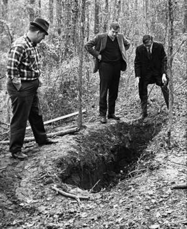 Investigators and reporters peer into the hole where Gary Krist buried Barbara Jane Mackle alive in a box near South Berkeley Lake Road in Gwinnett County in 1968. The kidnapper more recently became a doctor. AP Wire Photo