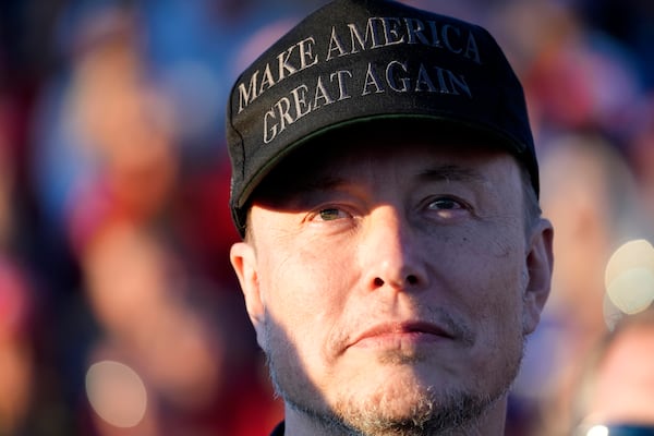 FILE - Tesla and SpaceX CEO Elon Musk listens as Republican presidential nominee former President Donald Trump speaks at a campaign event at the Butler Farm Show, Oct. 5, 2024, in Butler, Pa. (AP Photo/Alex Brandon, File)