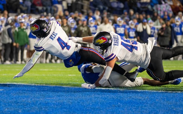 Kansas Jayhawks running back Devin Neal (4) crosses the goal line, for a touchdown, as Kansas tight end Trevor Kardell (45) blocks during an NCAA college football game against the BYU, Saturday, Nov. 16, 2024, in Provo. (AP Photo/Rick Egan)