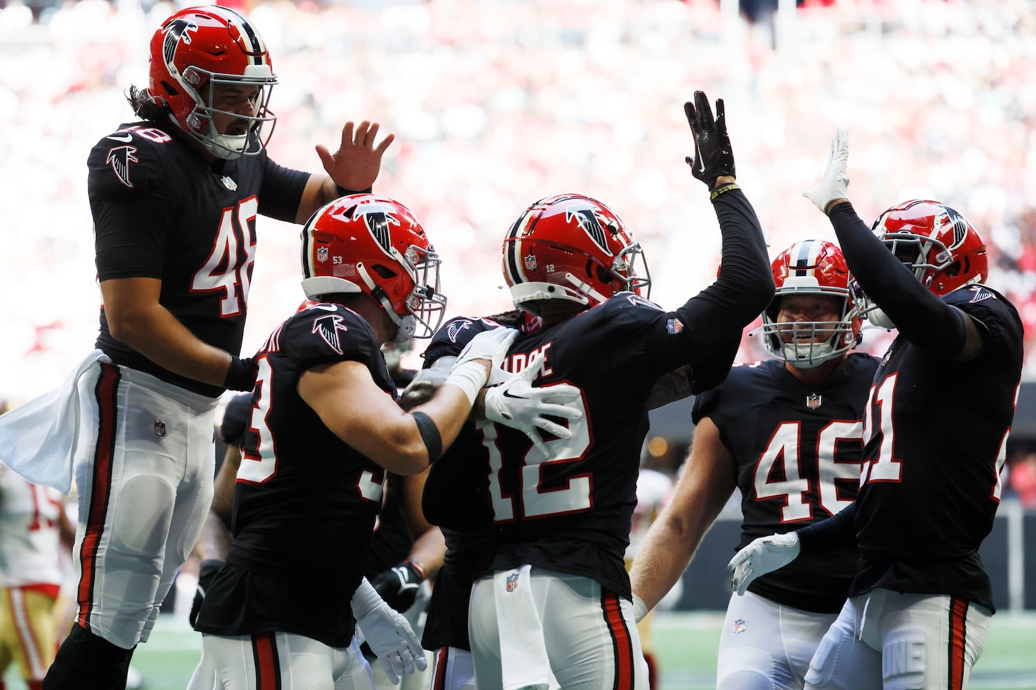 Falcons players celebrate after they stopped the 49ers during the third quarter Sunday at Mercedes-Benz Stadium. (Miguel Martinez / miguel.martinezjimenez@ajc.com)