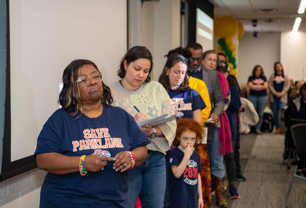 Parents, teachers, students and community members, including Marie Terry, a parent and River Park resident, waits for her public comment time at the Feb. 20, 2025 Fulton County school board meeting to show support for Parklane Elementary School in East Point.  (Jenni Girtman for The Atlanta Journal-Constitution)