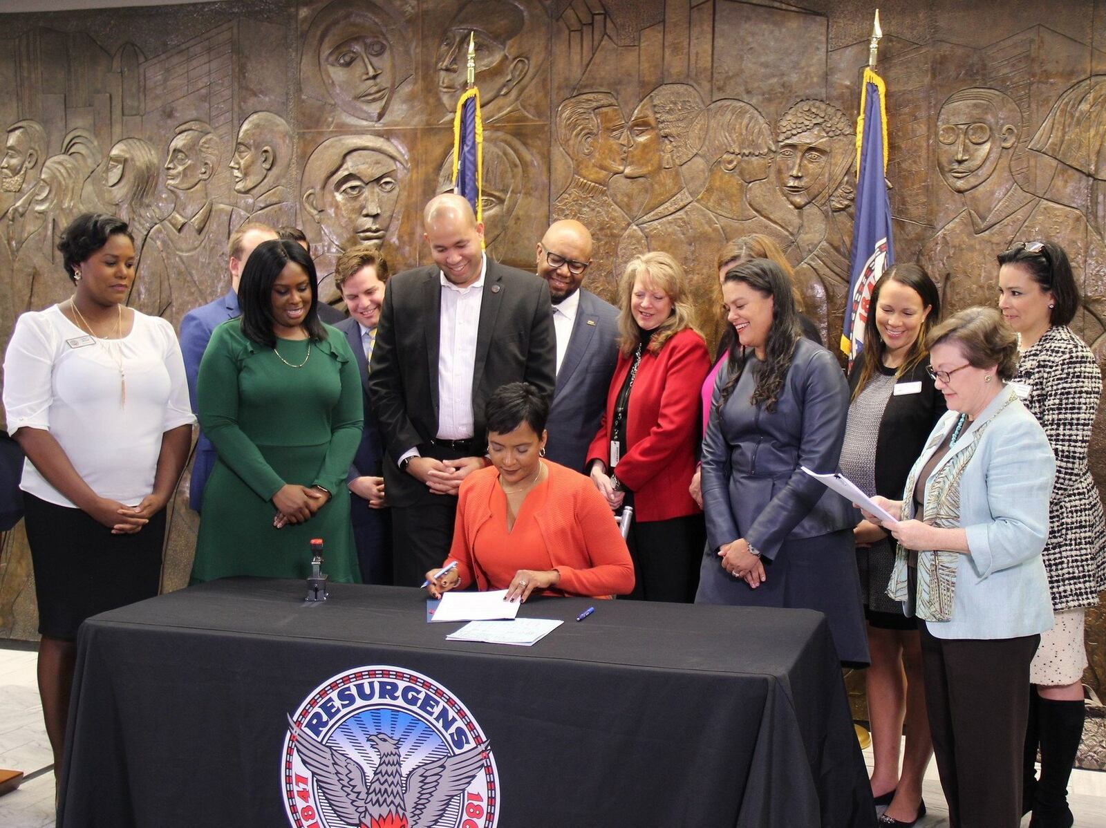 Mayor Keisha Lance Bottoms, center, is surrounded by Atlanta school board members and the school superintendent as she signs documents turning over deeds to 31 Atlanta Public Schools properties on Feb. 20, 2018. Photo from Atlanta Public Schools Twitter account.