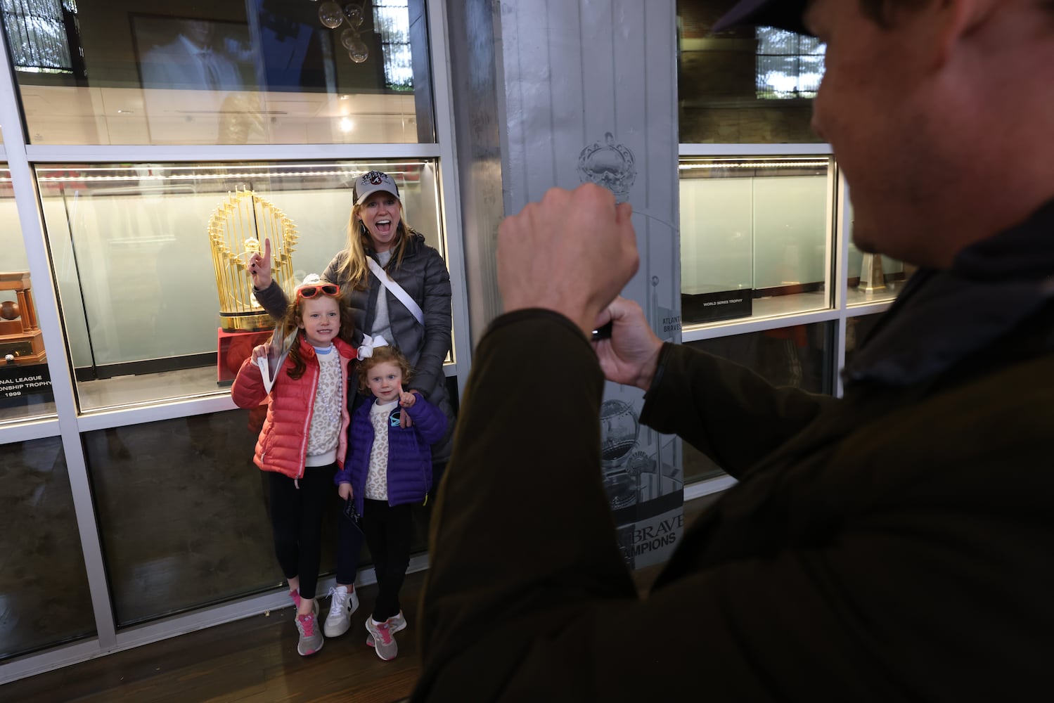 Brad McAdams from  Atlanta takes a photo of his family in front of the 1995 World Series Championship on the hallways of the Truist Stadium. The Atlanta Braves are on the route to the stadium to celebrate with their fans the World Series Championship.on Friday, November 5, 2021.
Miguel Martinez for The Atlanta Journal-Constitution