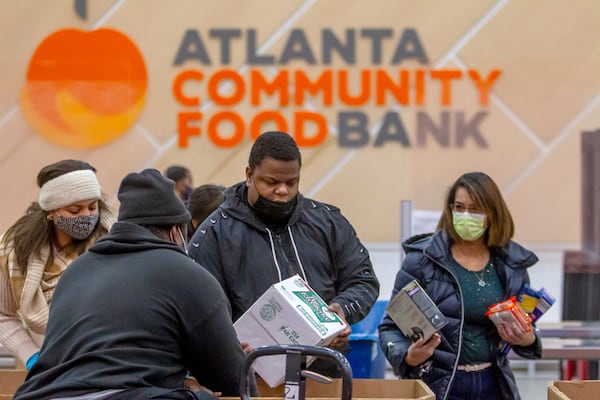 Hunger Action volunteers sort food into their appropriate boxes at the Atlanta Community Food Bank Thursday, 23, 2021.   STEVE SCHAEFER FOR THE ATLANTA JOURNAL-CONSTITUTION