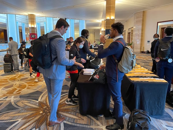 Georgia Bulldogs John FitzPatrick (L) and Nolan Smith pick up their room keys and care packages at the Intercontinental Hotel on Sunday in downtown Miami. (Photo by Chip Towers/ctowers@ajc.com)