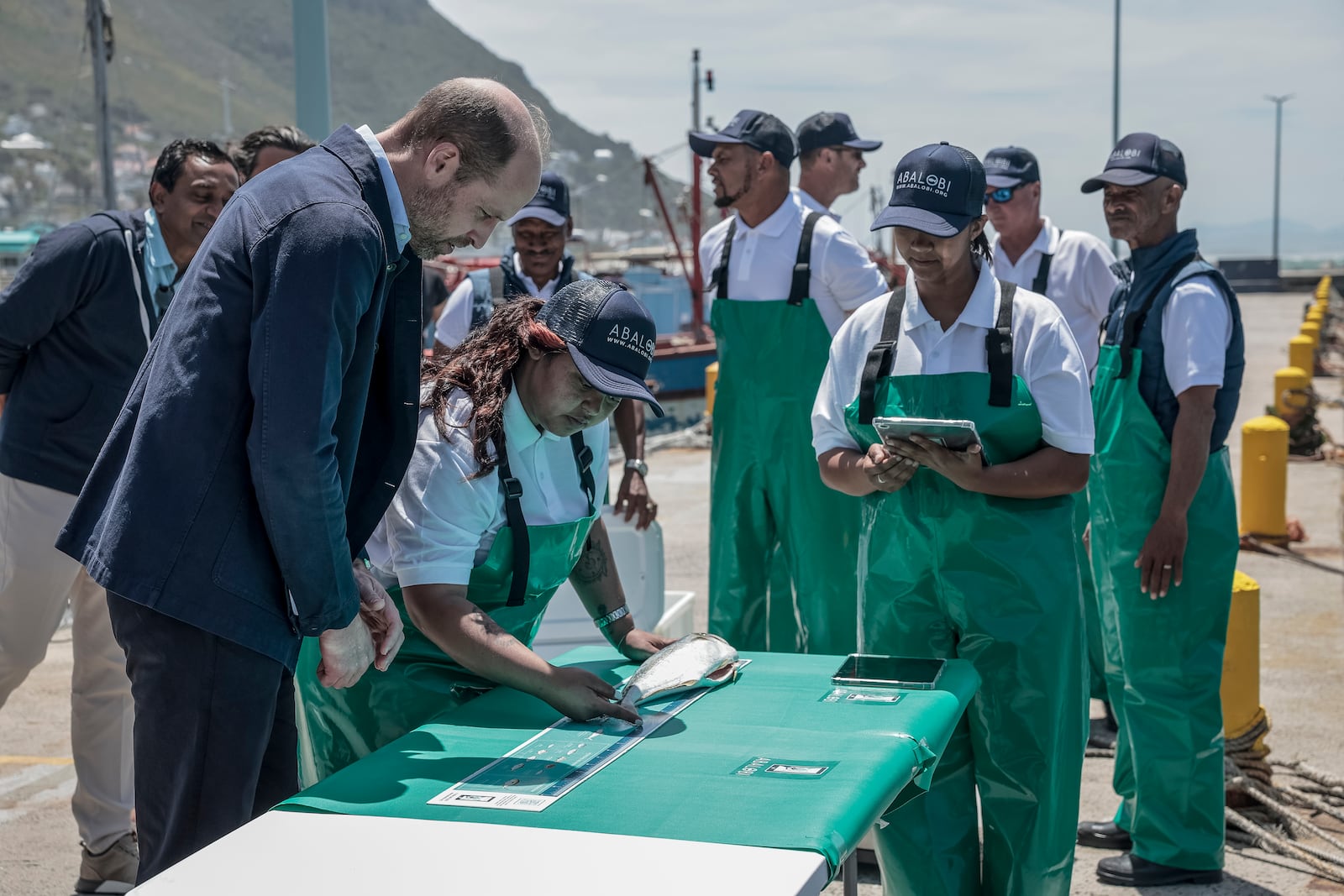 Britain's Prince William, the Prince of Wales, is shown 2023 Earthshot finalist ABALOBI's game-changing technology to register and log catches, to local fisherman, at Kalk Bay Harbour, near Cape Town, Thursday, Nov. 7, 2024. (Gianluigi Guercia/Pool Photo via AP)