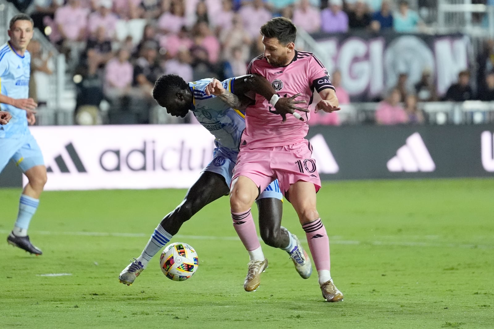 Atlanta United forward Jamal Thiaré (29) and Inter Miami forward Lionel Messi (10) go after the ball during the first half of match one of their MLS playoff opening round soccer match, Friday, Oct. 25, 2024, in Fort Lauderdale, Fla. (AP Photo/Rebecca Blackwell)