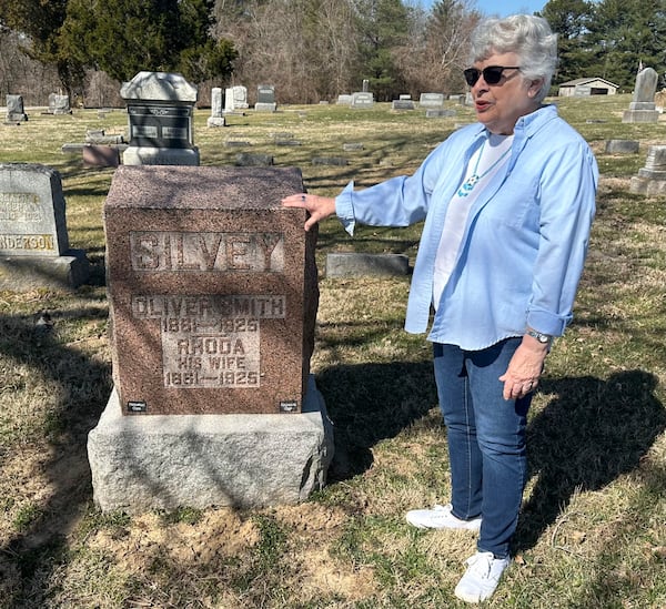 Sylvia Carvell, 81, of Murphybsoro, appears in this March 11, 2025 photo near the grave in Tower Grove Cemetery of her great-grandparents, (AP Photo/John O'Connor)