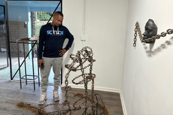 Visitor Eric Boswell discovers Georgia State senior linebacker Justin Abraham's "Caretaker" piece during the "Reimagining Success" exhibit in Decatur on Nov. 4, 2024. (Courtesy of Stan Awtrey)