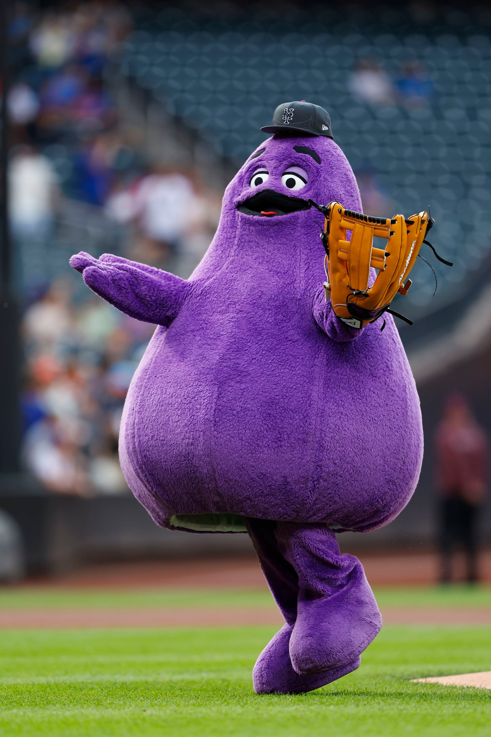 FILE - McDonald's character Grimace throws out a ceremonial first pitch before a baseball game between the Miami Marlins and the New York Mets, June 12, 2024, in New York. (AP Photo/Rich Schultz, File)